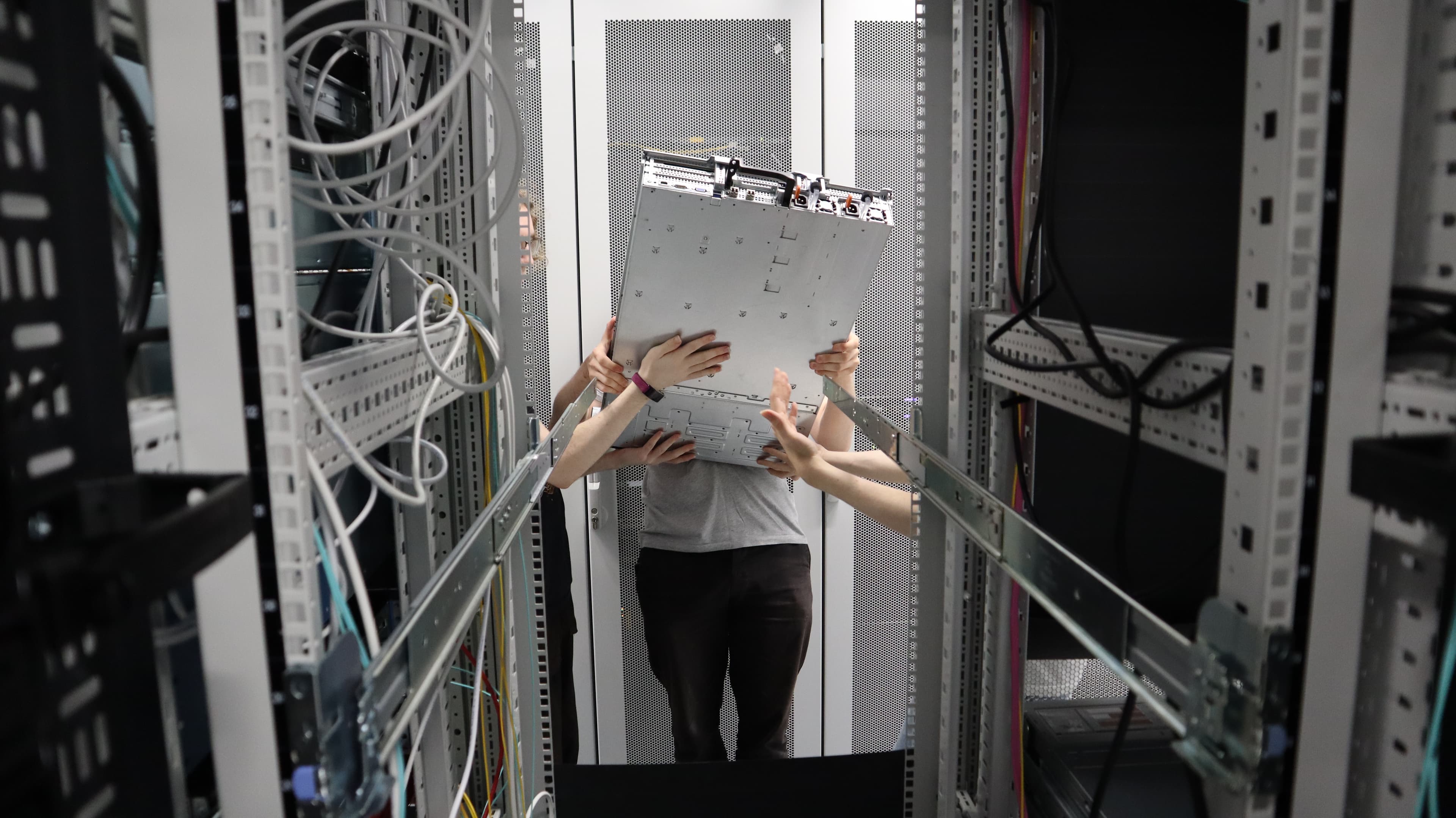 A photograph of the server Atwood being loaded in the server rack.